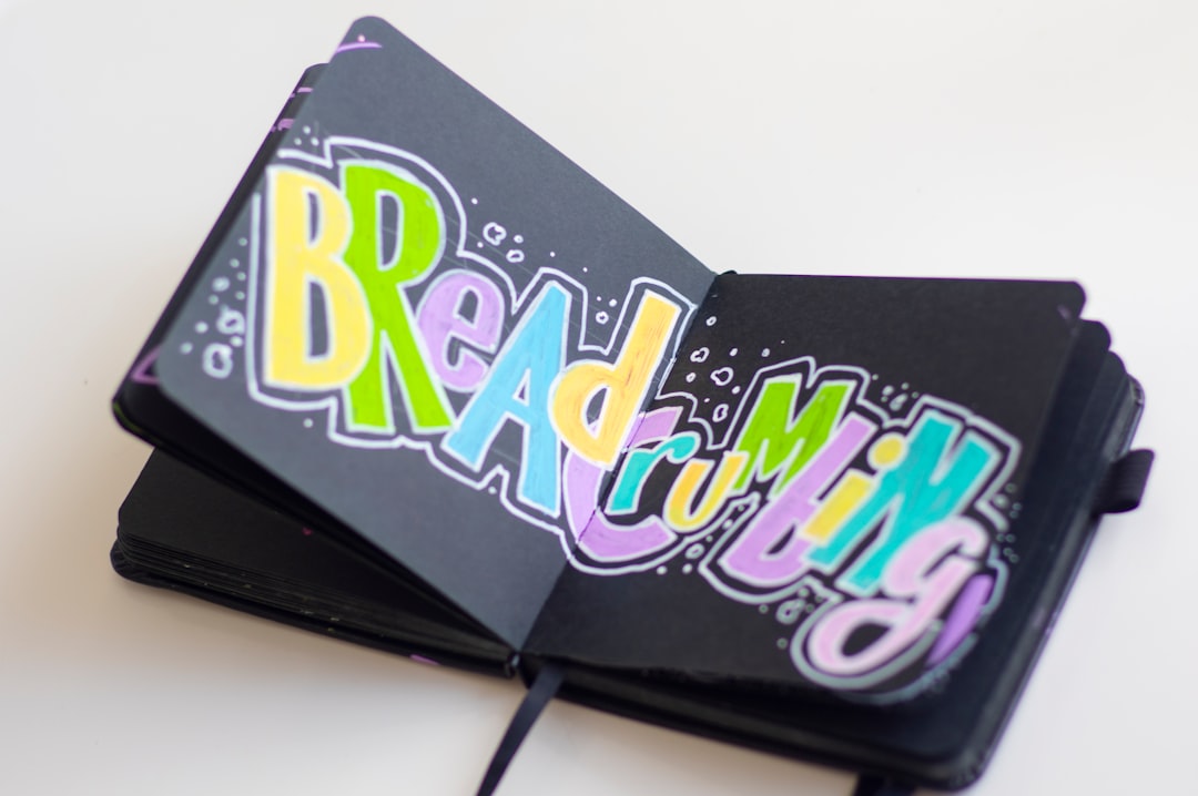 Young attractive painter is holdind jar with brushes in her own cozy workshop